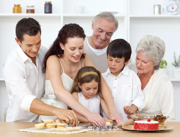 Anne, büyükanne ve büyükbaba ve çocuk mutfakta pişirme — Stok fotoğraf