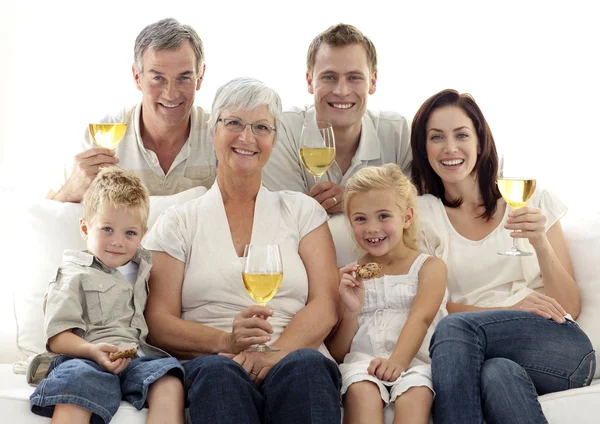 Portrait of family drinking wine and children eating biscuits — Stock Photo, Image