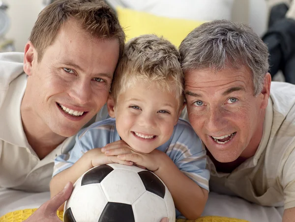 Portrait of smiling son, father and grandfather on floor — Stock Photo, Image