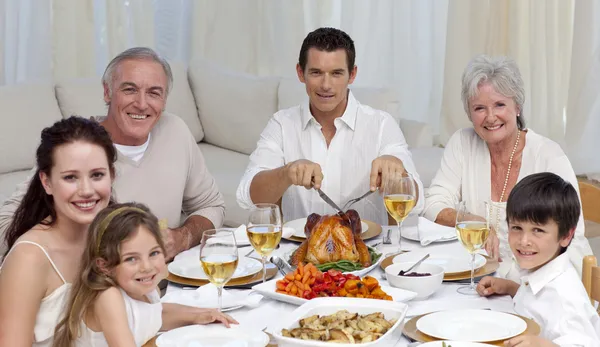 Family eating turkey and vegetables in a celebration meal — Stock Photo, Image