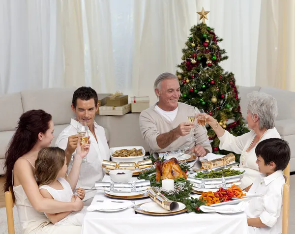 Grandparents and parents tusting in a Christmas dinner — Stock Photo, Image