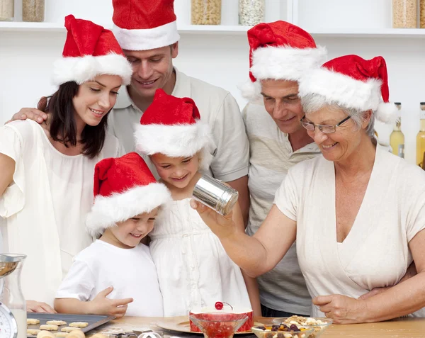 Happy family baking Christmas cakes — Stock Photo, Image