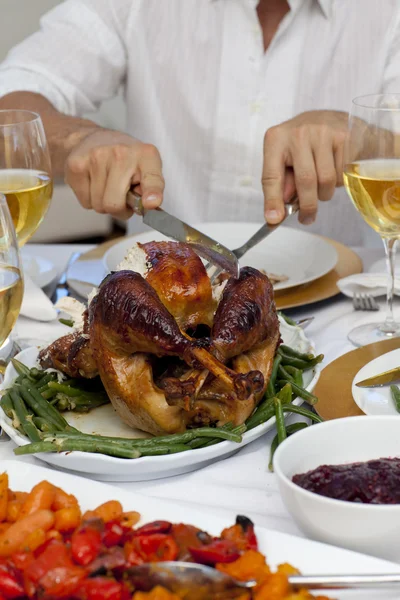Close-up of a man cutting a turkey for Christmas dinner — Stock Photo, Image