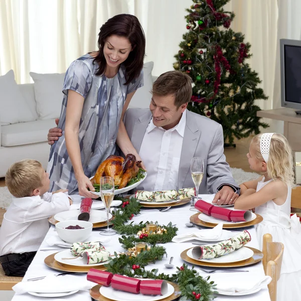 Parents and children in Christmas dinner with turkey — Stock Photo, Image