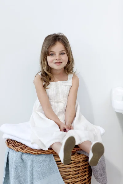 Little girl sitting in bathroom — Stock Photo, Image