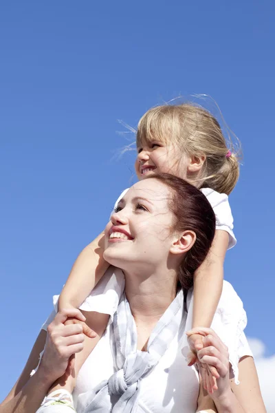 Mother giving her daughter piggyback ride — Stock Photo, Image