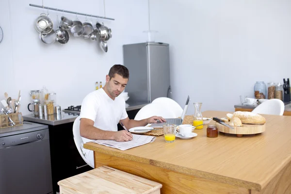 stock image Busy man having breakfast and working in kitchen