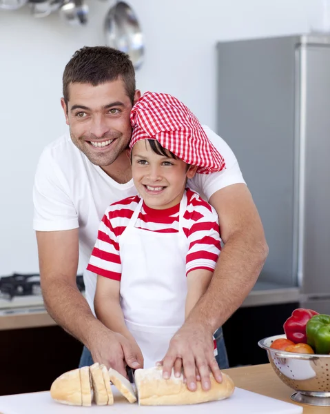 Father and son cutting bread — Stock Photo, Image