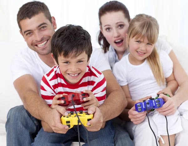 Family playing video games at home — Stock Photo, Image