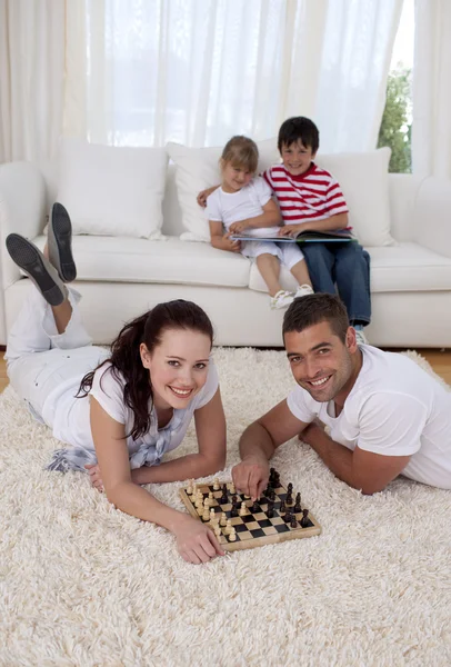 Couple playing chess on floor in living-room — Stock Photo, Image