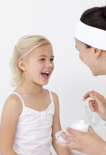 Mother and daughter having fun with cream — Stock Photo, Image