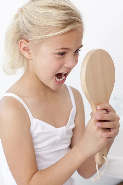 Little girl having fun with a mirror — Stock Photo, Image
