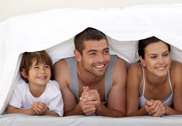 Son and parents playing under the bedsheets — Stock Photo, Image