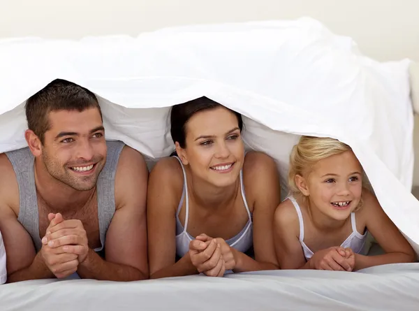 Parents and daughter under the sheets — Stock Photo, Image