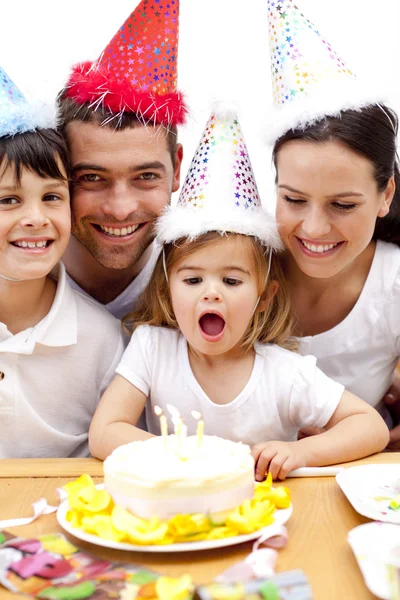 Little girl blowing out candles in her birthday's day — Stock Photo, Image