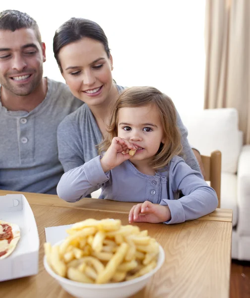 フライド ポテト、ピザを家で食べる小さな女の子 — ストック写真