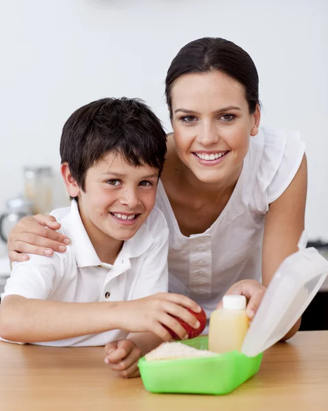 Smiling mother and son making the school lunch — Stock Photo, Image