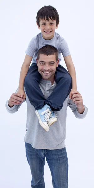 Father giving son piggyback against white — Stock Photo, Image