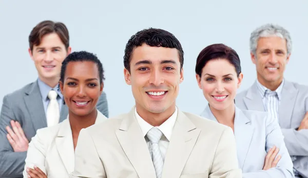 Multi-ethnic business standing with folded arms Stock Image