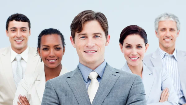 Multi-ethnic business partners standing with folded arms Stock Picture