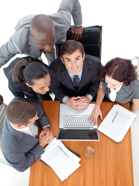Businessteam working with their boss with a laptop Stock Picture