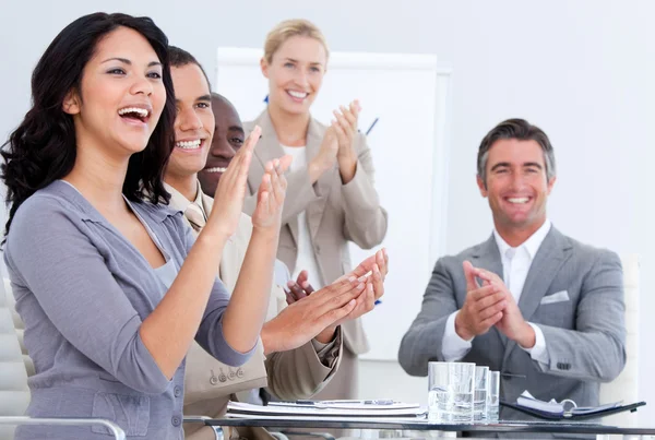 Glada business applåderar i ett möte Stockbild
