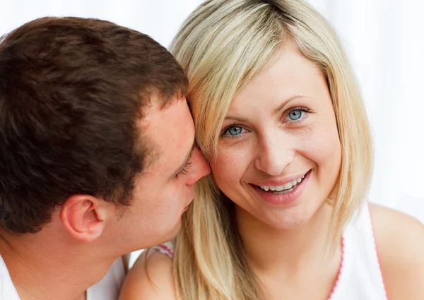 Man whispering a woman something funny Stock Picture