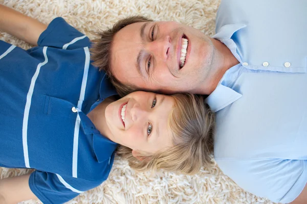 Animated father and his son lying on the floor — Stock Photo, Image