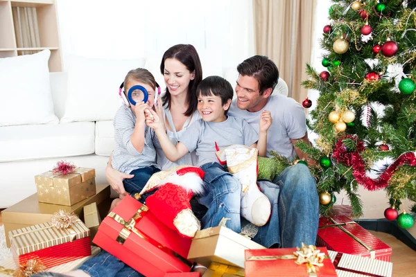Happy family having fun with Christmas presents Stock Photo