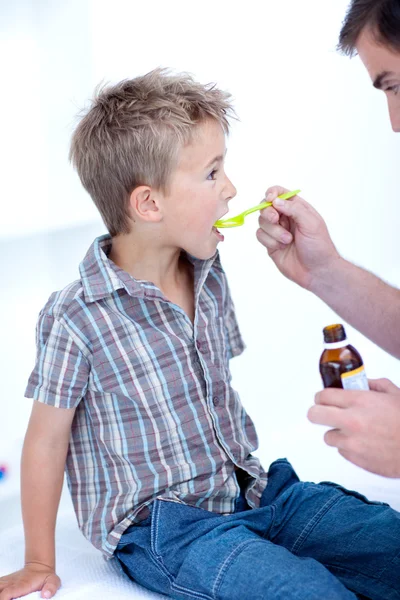 Child taking cough medicine Stock Photo