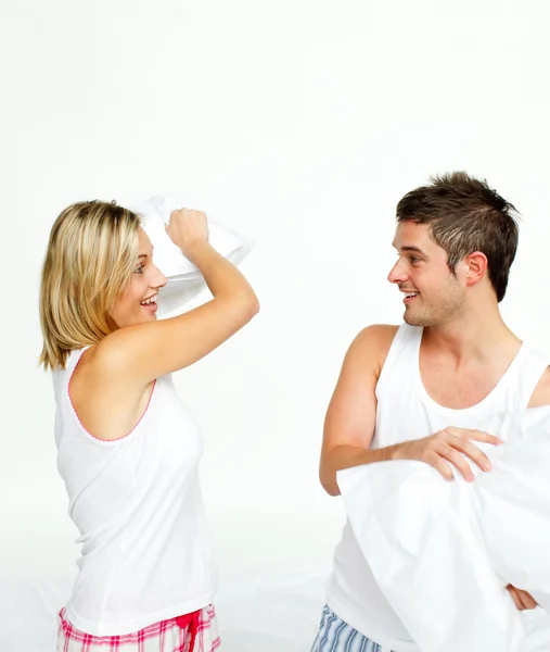 Young couple having a pillow fight Royalty Free Stock Images