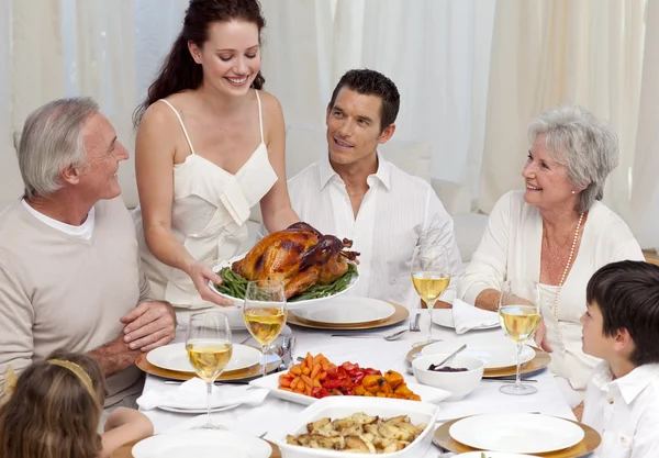 Woman showing turkey to her family for Christmas dinner Royalty Free Stock Images