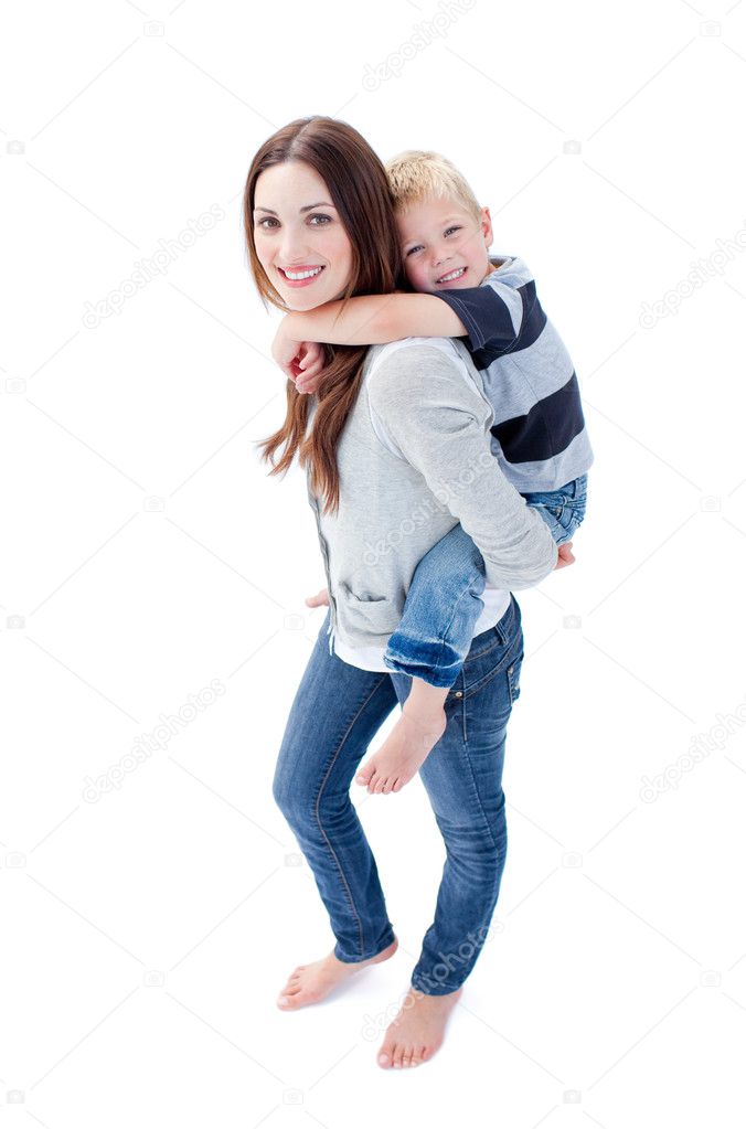 Happy mother giving her son a piggyback ride in the city stock photo