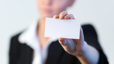 Business woman holding out a business card clipart