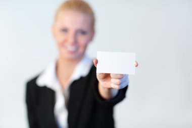 Smiling Business woman holding out a business card clipart