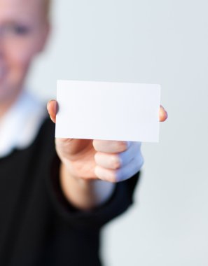 Smiling Business woman holding out a business card clipart