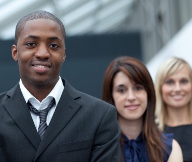 Afro-American businessman in front of his colleages clipart