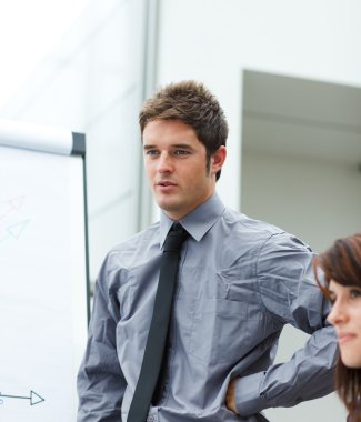 Young businessman reporting to sales figures clipart