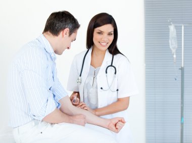 Smiling female doctor making injection to her patient clipart