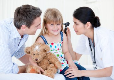 Smiling girl looks happy with her teddy bear clipart