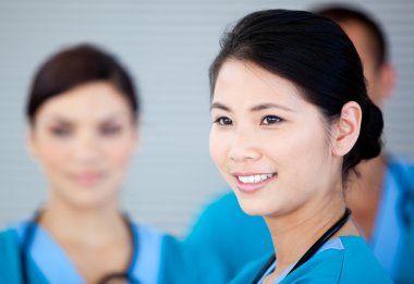 Smiling female doctor with her teamates clipart