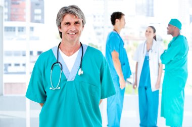 Joyful male doctor looking at the camera while his medical partn clipart