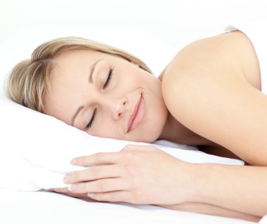 Radiant woman sleeping on her bed clipart