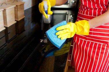 Close-up of a young woman doing housework clipart