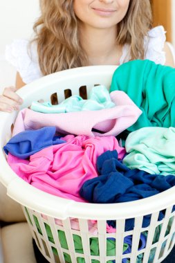 Close-up of a young woman doing laundry clipart