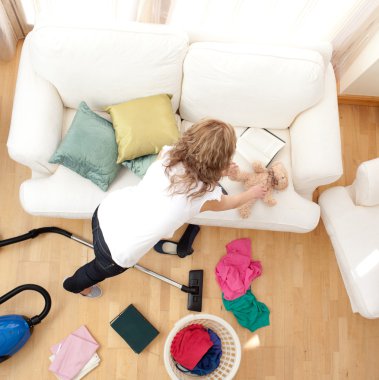 Blong young woman doing housework clipart