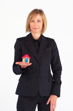 Mature businesswoman holding a house clipart