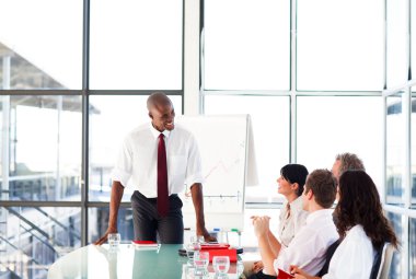 Attractive businessman talking in a meeting clipart