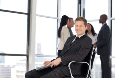 Businesss man in office sitting on chair clipart