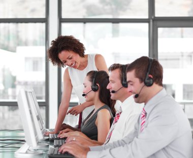 Female leader managing her team in a call center clipart